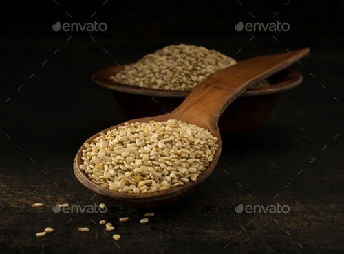 A wooden spoonful of sesame seeds